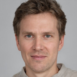 Joyful white adult male with short  brown hair and grey eyes