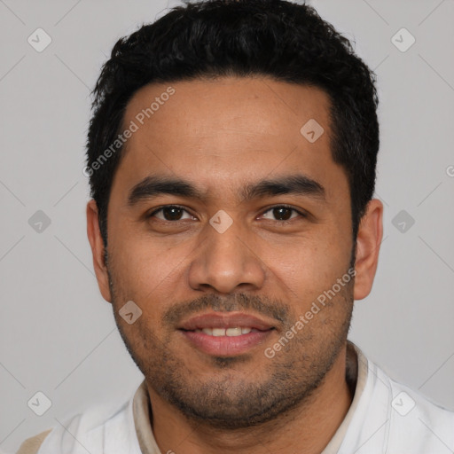 Joyful latino young-adult male with short  black hair and brown eyes