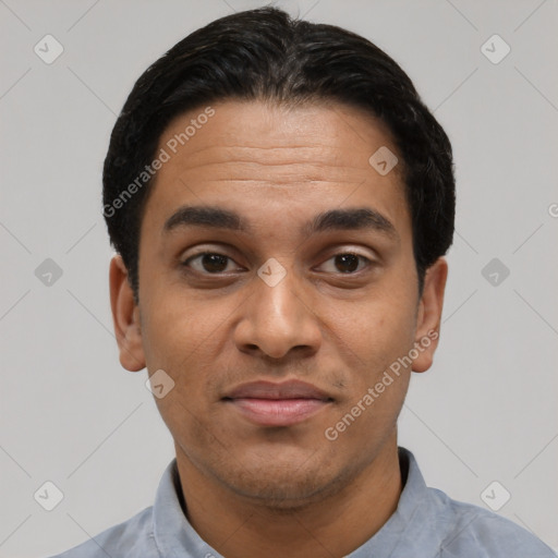 Joyful latino young-adult male with short  black hair and brown eyes