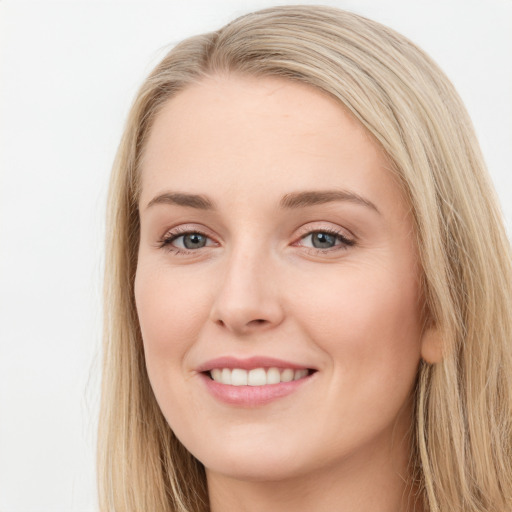 Joyful white young-adult female with long  brown hair and blue eyes