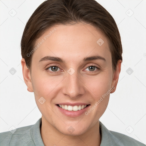 Joyful white young-adult female with short  brown hair and grey eyes