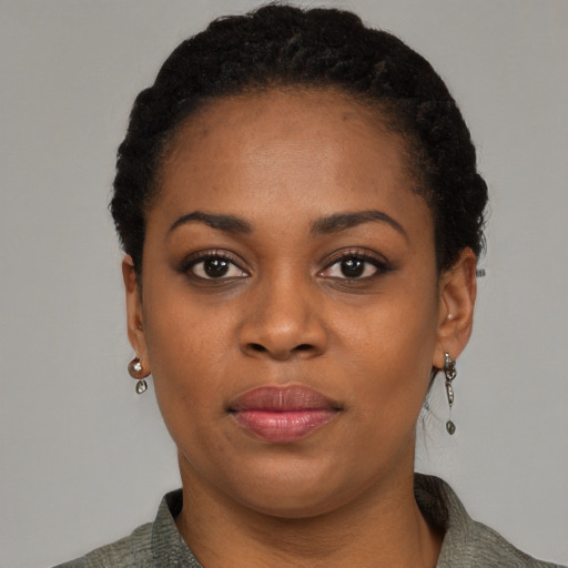Joyful black young-adult female with short  black hair and brown eyes