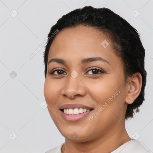 Joyful latino young-adult female with short  black hair and brown eyes