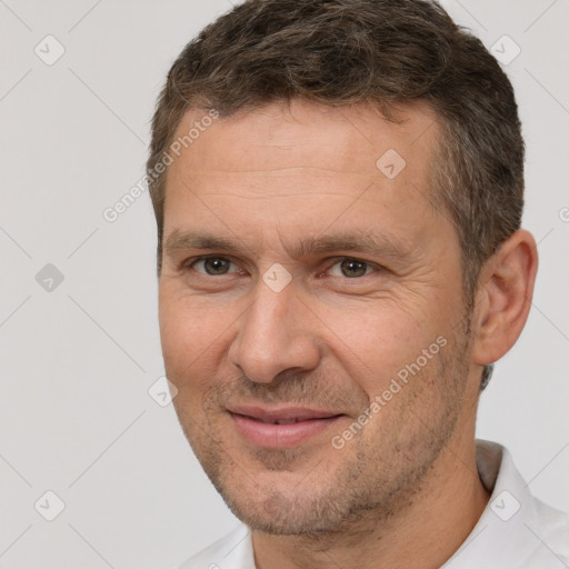 Joyful white adult male with short  brown hair and brown eyes