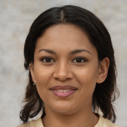 Joyful latino young-adult female with medium  brown hair and brown eyes