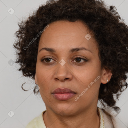 Joyful black adult female with medium  brown hair and brown eyes