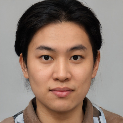 Joyful asian young-adult male with medium  brown hair and brown eyes