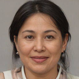 Joyful white adult female with medium  brown hair and brown eyes