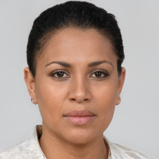 Joyful latino young-adult female with short  brown hair and brown eyes