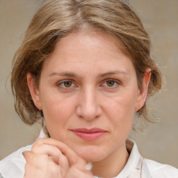 Joyful white adult female with medium  brown hair and blue eyes