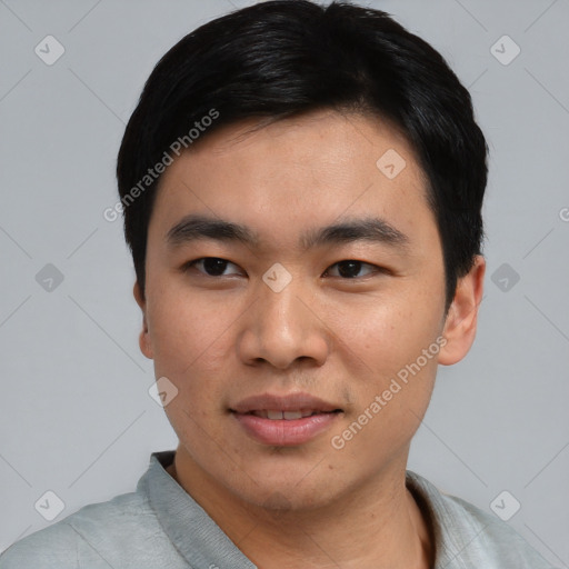 Joyful asian young-adult male with short  black hair and brown eyes