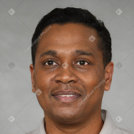 Joyful black adult male with short  black hair and brown eyes
