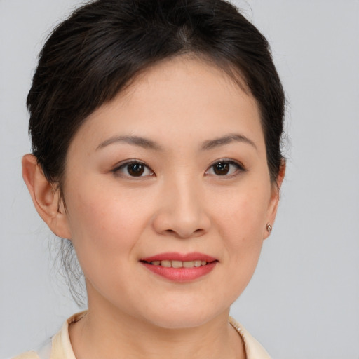 Joyful white young-adult female with medium  brown hair and brown eyes