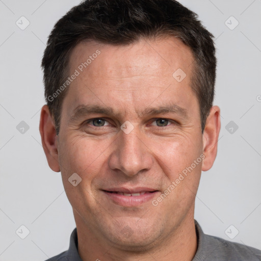 Joyful white adult male with short  brown hair and brown eyes