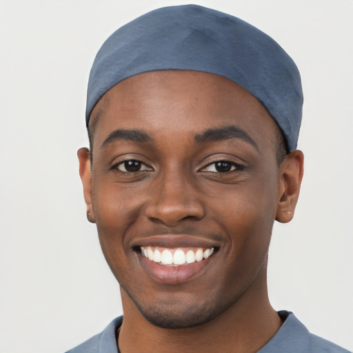 Joyful black young-adult male with short  black hair and brown eyes