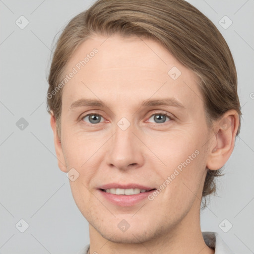 Joyful white young-adult male with short  brown hair and grey eyes