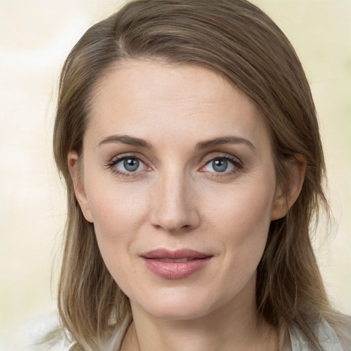 Joyful white young-adult female with medium  brown hair and grey eyes