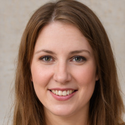 Joyful white young-adult female with long  brown hair and grey eyes