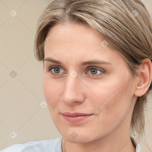 Joyful white young-adult female with medium  brown hair and blue eyes