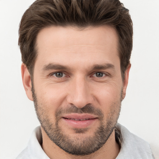 Joyful white young-adult male with short  brown hair and brown eyes