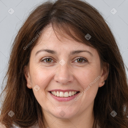 Joyful white adult female with long  brown hair and brown eyes