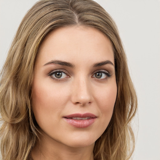 Joyful white young-adult female with long  brown hair and green eyes