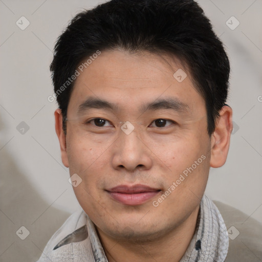 Joyful asian young-adult male with short  black hair and brown eyes