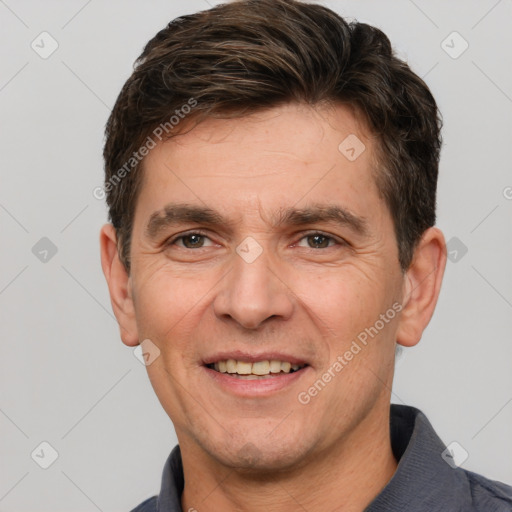 Joyful white adult male with short  brown hair and brown eyes