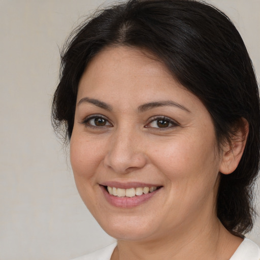 Joyful white adult female with medium  brown hair and brown eyes
