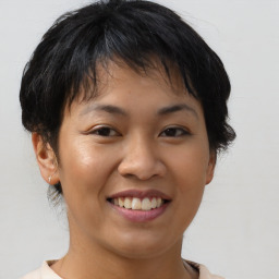 Joyful asian young-adult female with short  brown hair and brown eyes