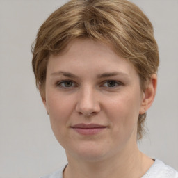 Joyful white young-adult female with short  brown hair and grey eyes