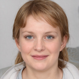 Joyful white young-adult female with medium  brown hair and blue eyes