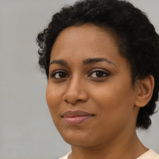 Joyful latino young-adult female with short  black hair and brown eyes