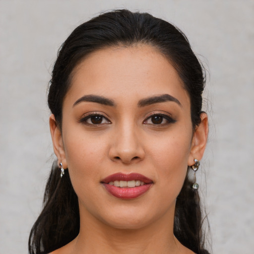 Joyful latino young-adult female with medium  brown hair and brown eyes