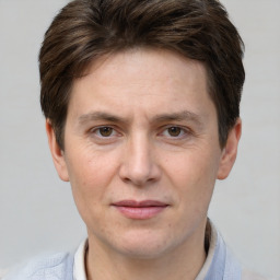 Joyful white adult male with short  brown hair and grey eyes