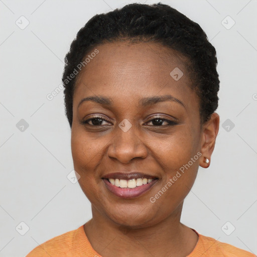 Joyful black young-adult female with short  black hair and brown eyes