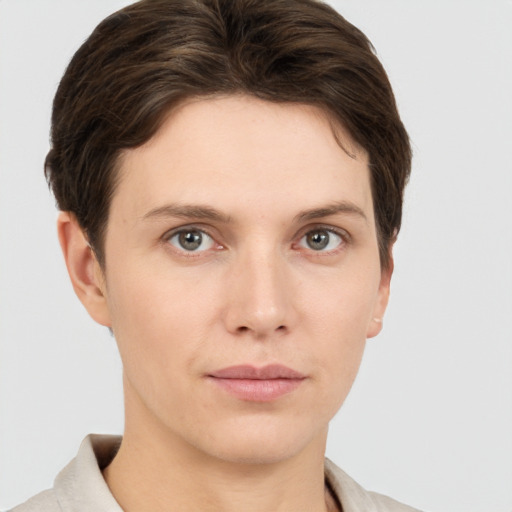 Joyful white young-adult female with short  brown hair and grey eyes