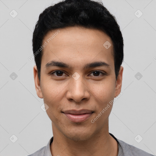 Joyful latino young-adult male with short  black hair and brown eyes