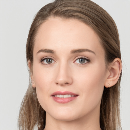 Joyful white young-adult female with long  brown hair and grey eyes