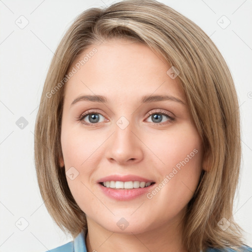 Joyful white young-adult female with medium  brown hair and blue eyes