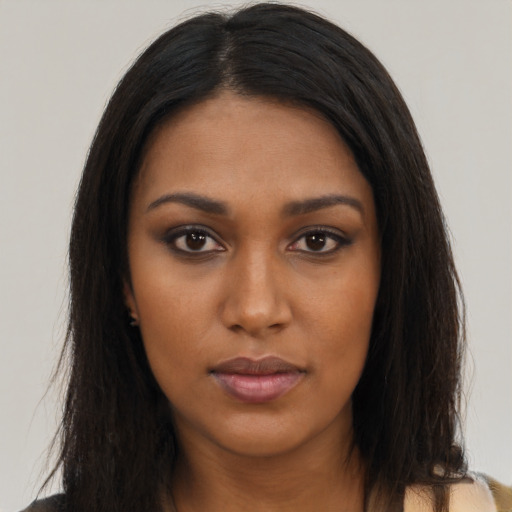 Neutral black young-adult female with long  brown hair and brown eyes