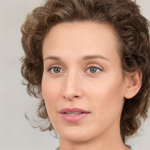 Joyful white young-adult female with medium  brown hair and green eyes