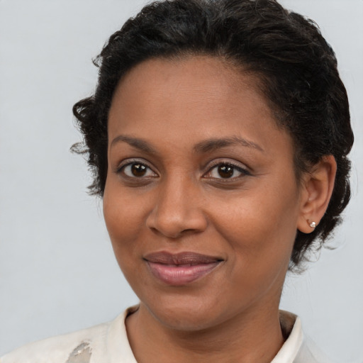 Joyful latino adult female with short  brown hair and brown eyes
