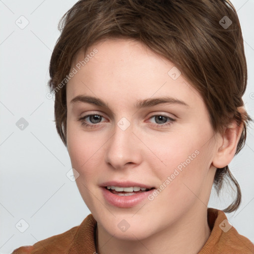 Joyful white young-adult female with medium  brown hair and grey eyes