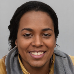 Joyful latino young-adult female with long  brown hair and brown eyes