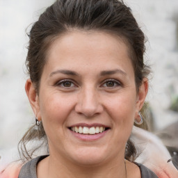 Joyful white adult female with medium  brown hair and brown eyes