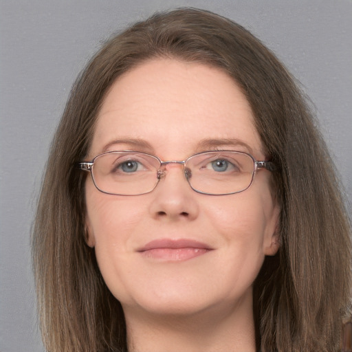 Joyful white adult female with long  brown hair and grey eyes