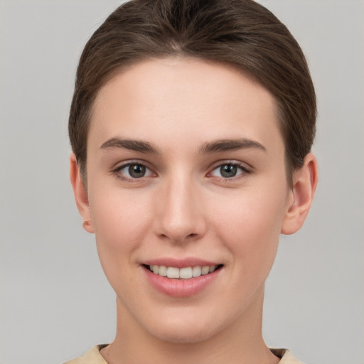 Joyful white young-adult female with short  brown hair and brown eyes