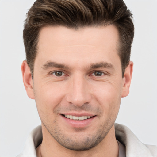 Joyful white young-adult male with short  brown hair and brown eyes