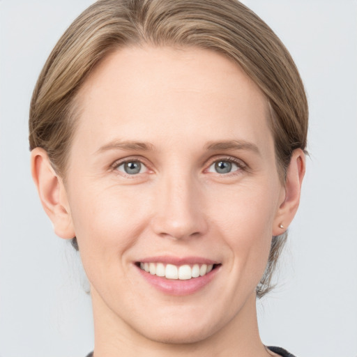 Joyful white young-adult female with medium  brown hair and blue eyes